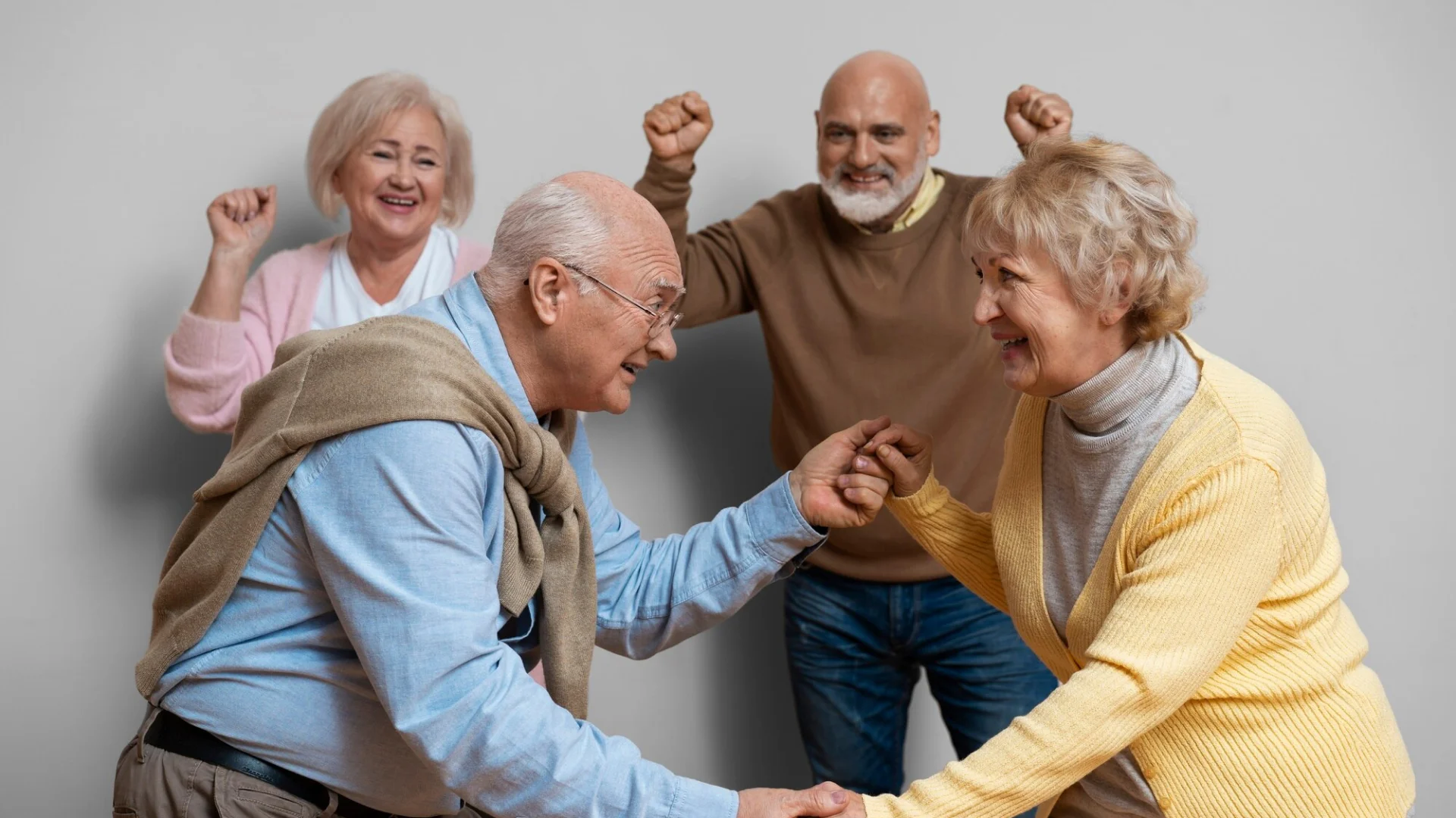 Seniors stretching arms together in a group activity.