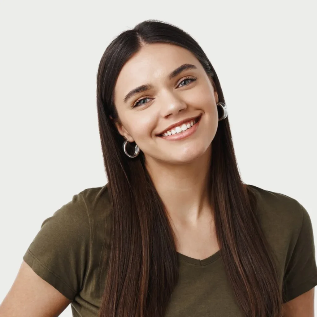 Woman with long dark hair posing in a studio.