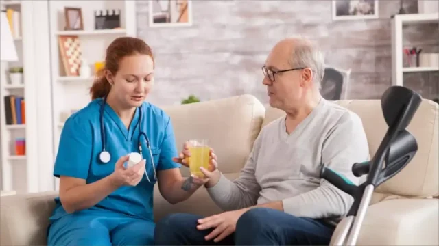 Nurse assisting senior man with medications