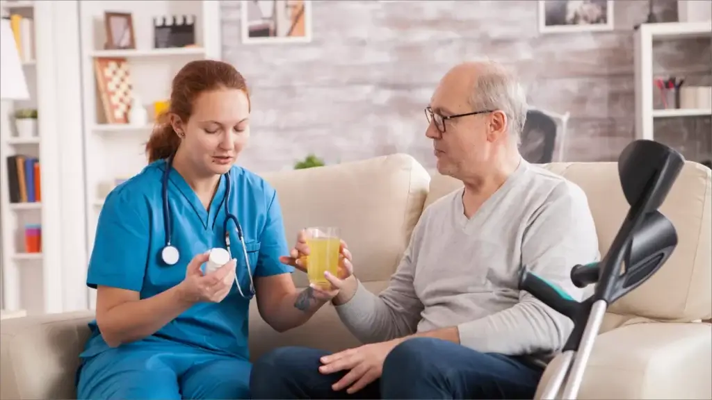Nurse assisting senior man with medications