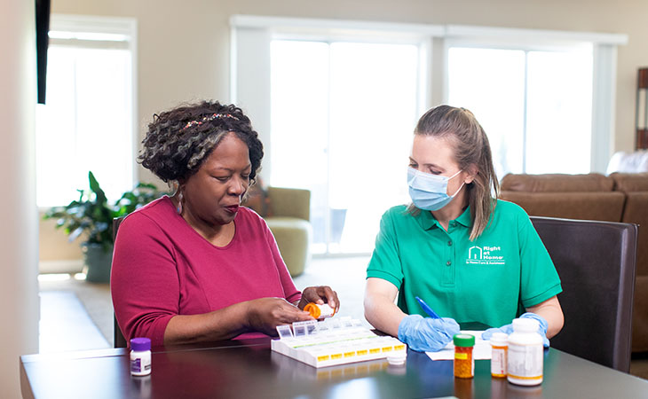 Nurse chatting with senior in a bright room.