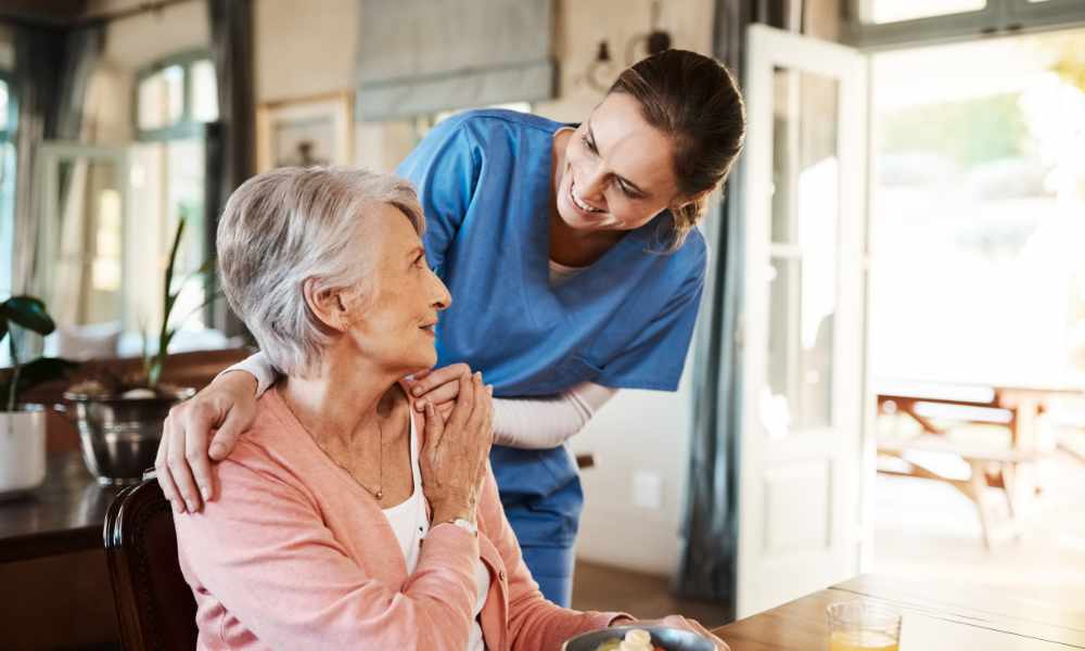 Nurse helping elderly woman at home.